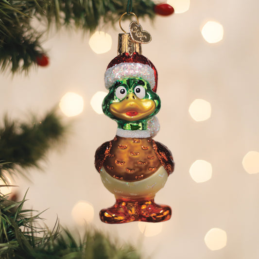 Christmas ornament of a duck with a Santa hat on a decorated tree.