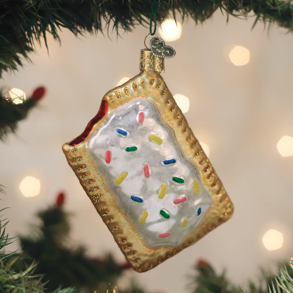 Decorative Christmas ornament shaped like a rectangle pop tart with sprinkles on a Christmas tree.