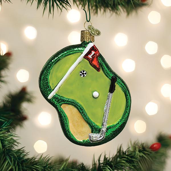 Golf ornament on a Christmas tree with lights in the background